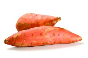 two sweet potatoes isolated on white