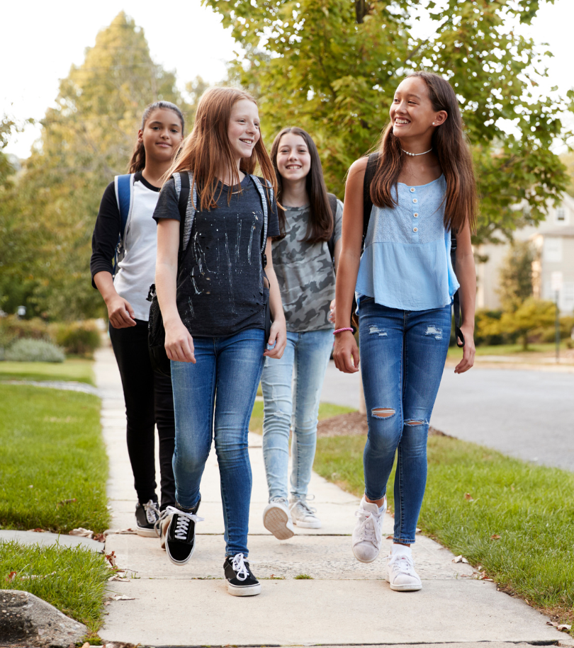 Four teen girls walking to school