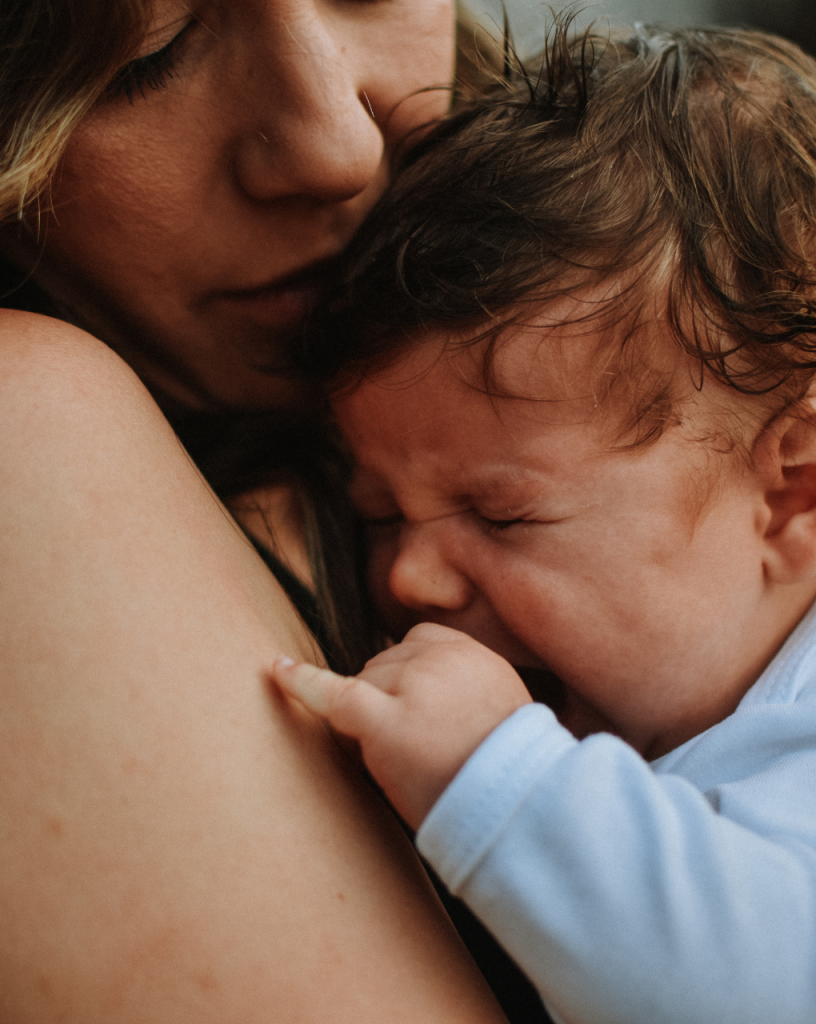 Mother holding her crying baby