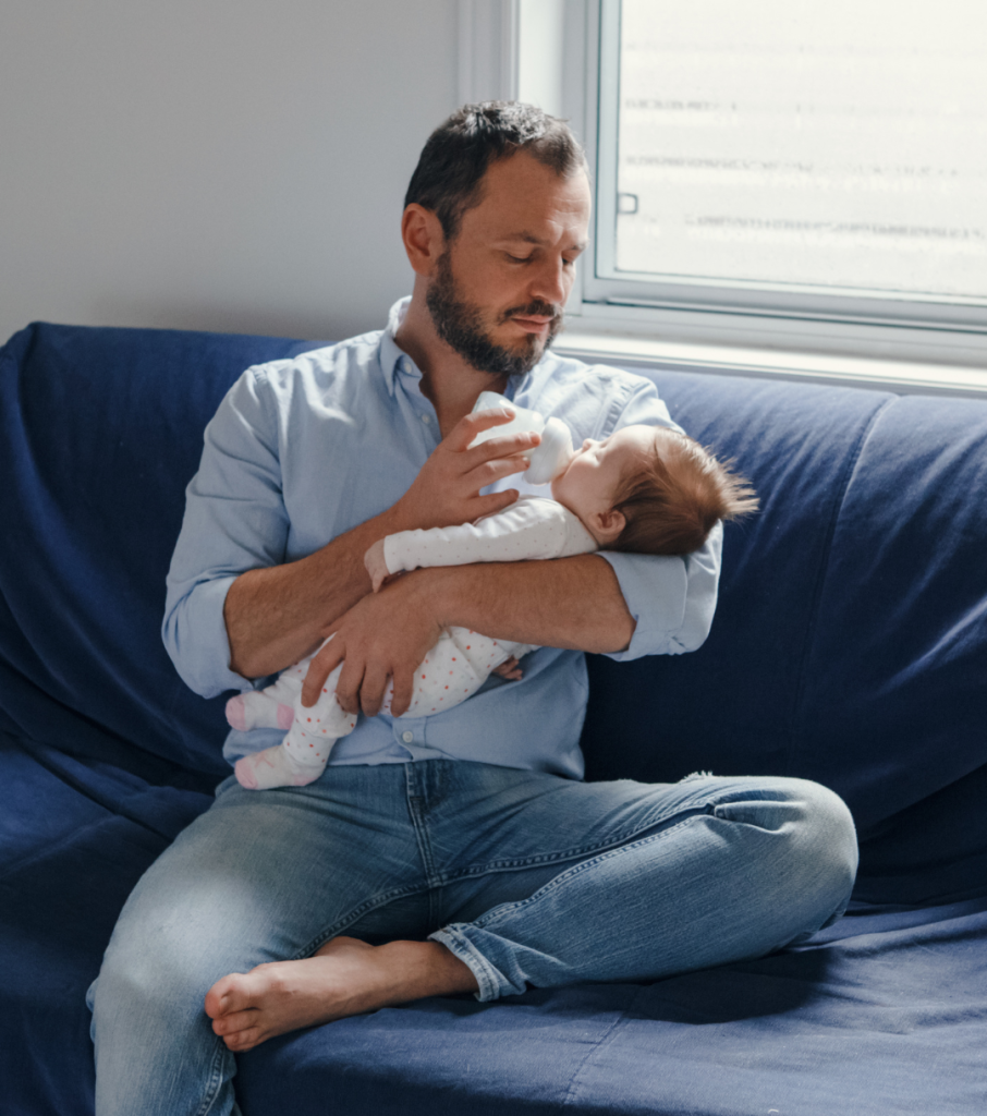 dad feeding baby with a bottle