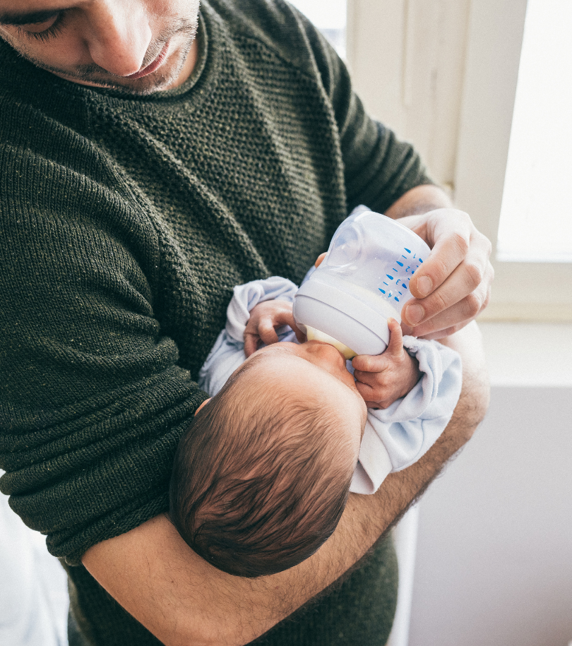 Man feeding his baby with a bottle