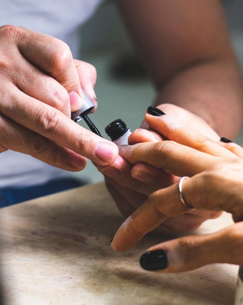 Woman getting her nails painted